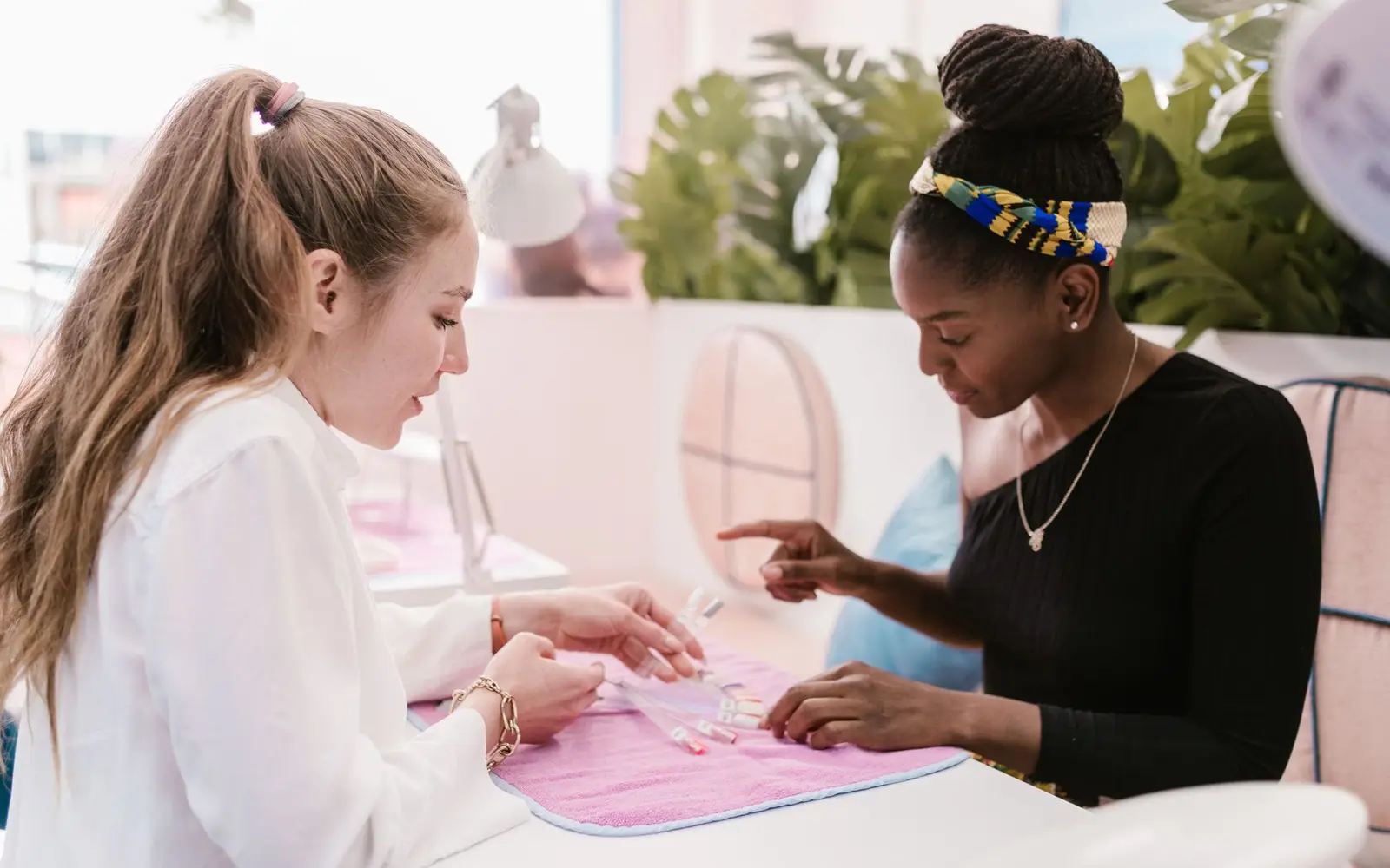 Pre-service consultation with a client over nail color swatches
