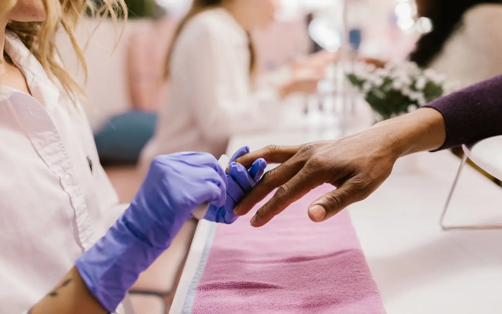 A client's hand on the manicure table during an appointment